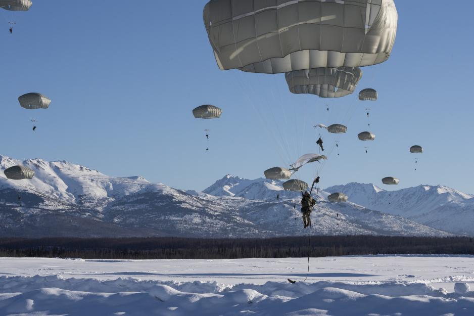 U.S. Army paratroopers jump over the Malemute Drop Zone in Alaska in March 2023. (Source: U.S. Air Force photo by Alejandro Peña) U.S. Army paratroopers