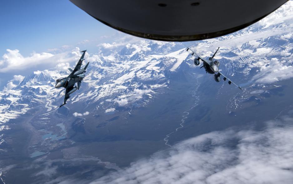 Two Japan Air Self-Defense Forces F-2 pilots fly behind a KC-135 Stratotanker Two Japan Air Self-Defense Forces F-2 pilots fly behind a KC-135 Stratotanker