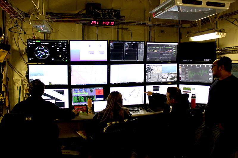Members of the hydrographic team from the National Oceanic and Atmospheric Administration Ship Fairweather and the University of New Hampshire analyze mapping data in the U.S. Coast Guard Cutter Healy’s computer lab while the cutter transits the Beaufort Sea, Oct. 16, 2024. (Source: U.S. Coast Guard photo by Lt. j.g. Haley Howard) mapping data, U.S. Coast Guard Cutter Healy