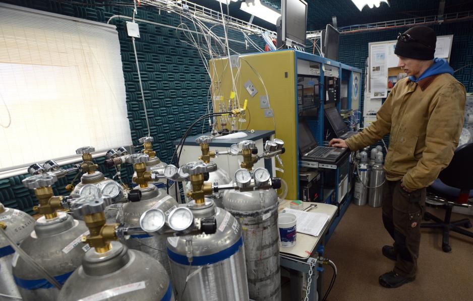 Technician Ross Burgener checks data collection as he staffs the NOAA Global Monitoring Division Barrow Observatory on September 21, 2015. Calibration tanks at left contain specific amounts of oxygen and other gases to verify the accuracy of analyzers on site. Air samples are collected, moisture is removed, and analyzers measure levels of methane, carbon dioxide, aerosols and other gases to add readings to an ongoing database begun in 1973. (Erik Hill / Alaska Dispatch News)