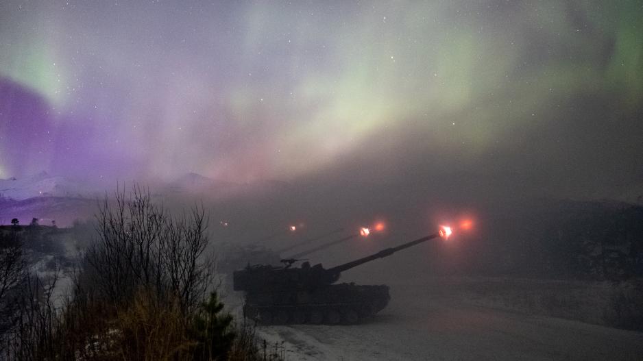 Arctic Bolt 2022: Den samlede Artilleribataljonen i Brigade Nord fyrer av langtrekkende ild og kruttrøyken formelig smelter sammen med nordlyset. (Foto: Ole-Sverre Haugli/Forsvaret)