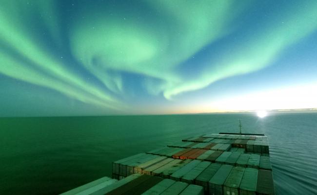 Maersk’s container ship Venta Maersk sailing along the Northern Sea Route under the aurora borealis. (Source: Courtesy of Maersk) Venta Maersk sailing through Arctic waters