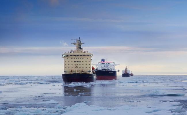 Rosatomflot icebreaker escorting a convoy of vessels through the icy waters of the Northern Sea Route.