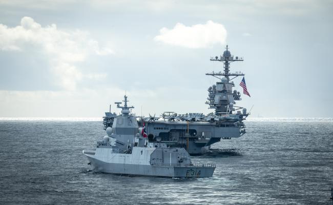 Den norske fregatten KNM Thor Heyerdahl ledsager USS Gerald R. Ford utenfor norskekysten. Hangarskipet er atomdrevet, 333 meter langt, 76 meter høyt – og 78 meter bredt. Om bord er et mannskap på rundt 4500 personer, og rom for rundt 90 fly og helikoptre. (Foto: Edward Valentin Coates/Forsvaret)